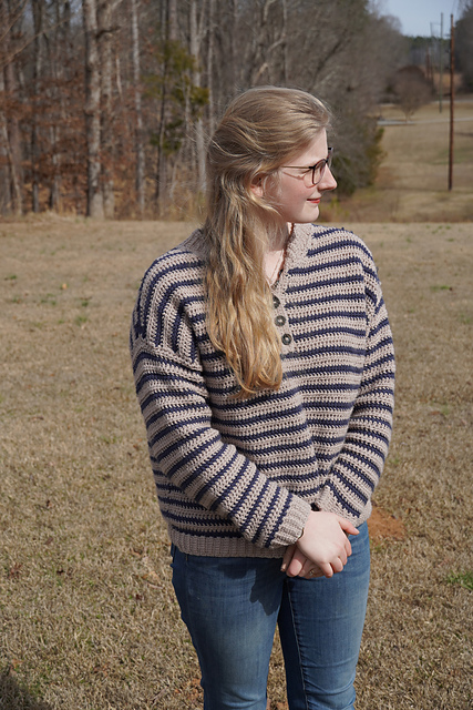 Romilly A. Moore outdoors, wearing a handmade striped crochet sweater